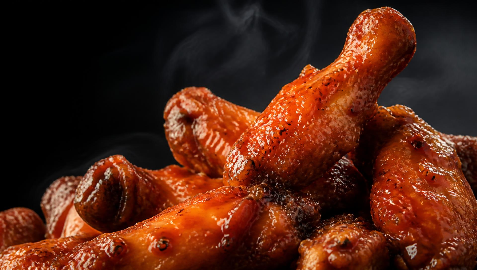 Close-up of glossy buffalo wings tossed in sauce